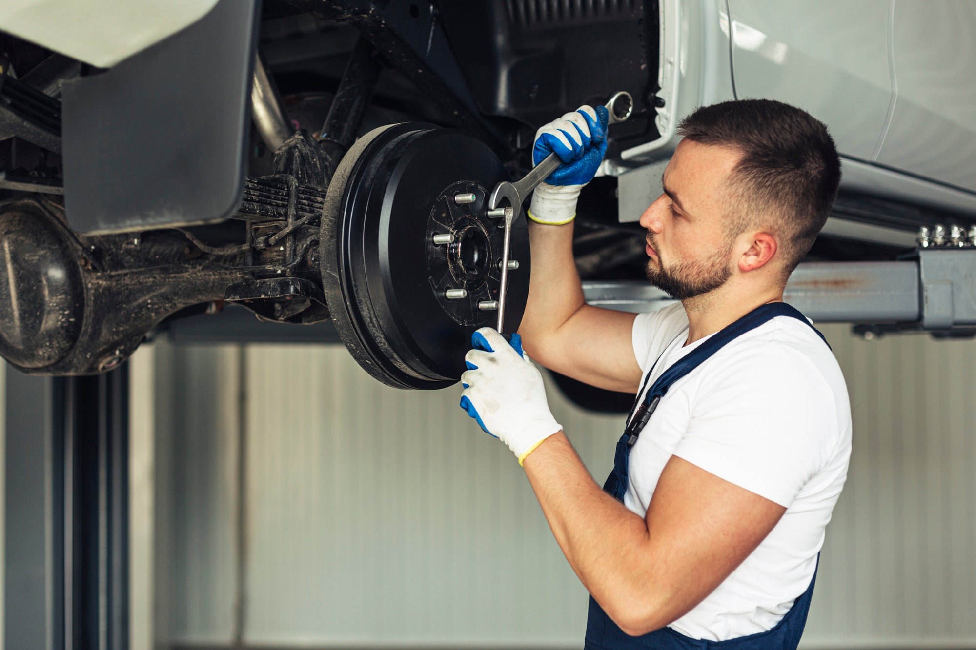 Mechanic conducting brake inspections