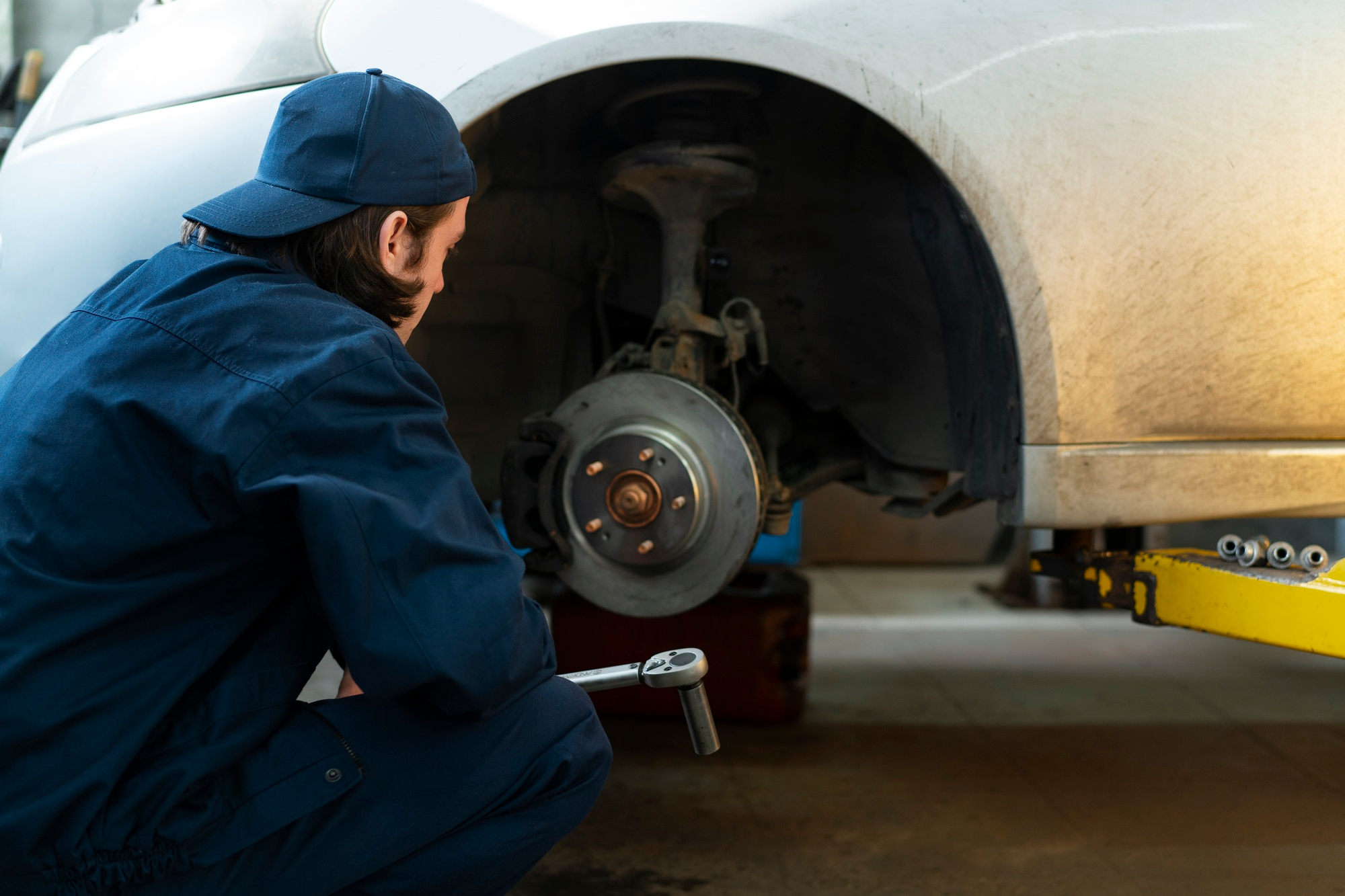 Mechanic inspecting brakes of a vehicle